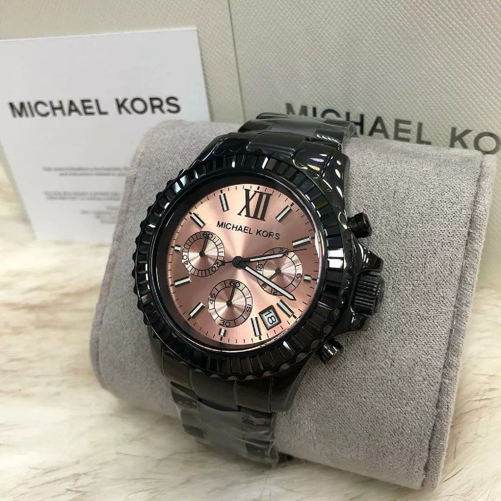 Michael Kors Everest watch on wrist displayed with branded box and documentation