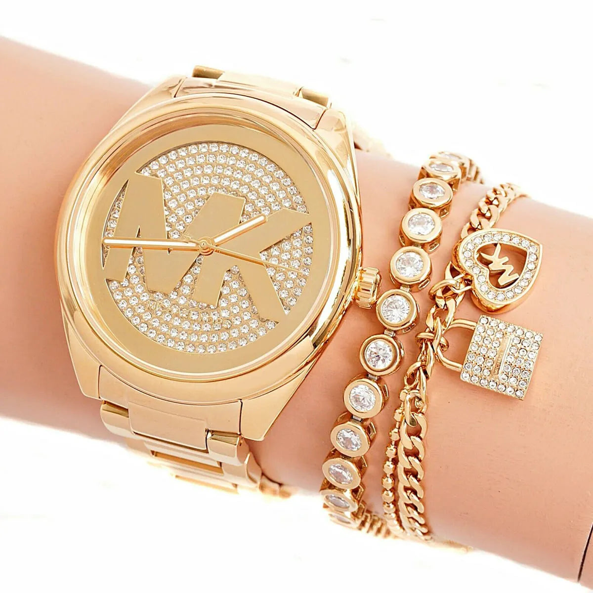 Michael Kors Janelle gold watch worn on wrist with complementary gold bracelets
