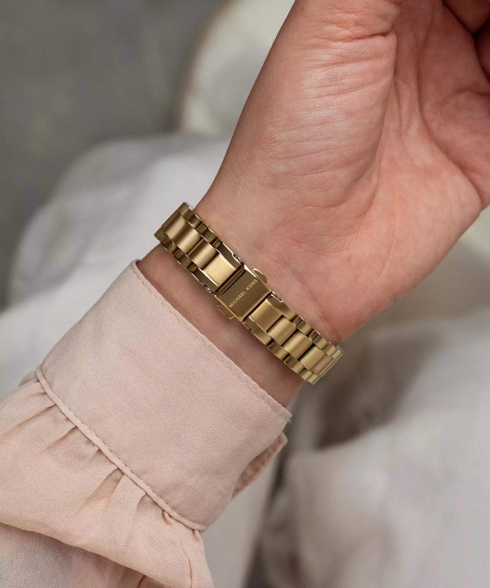 Michael Kors Lexington gold bracelet strap side view on wrist