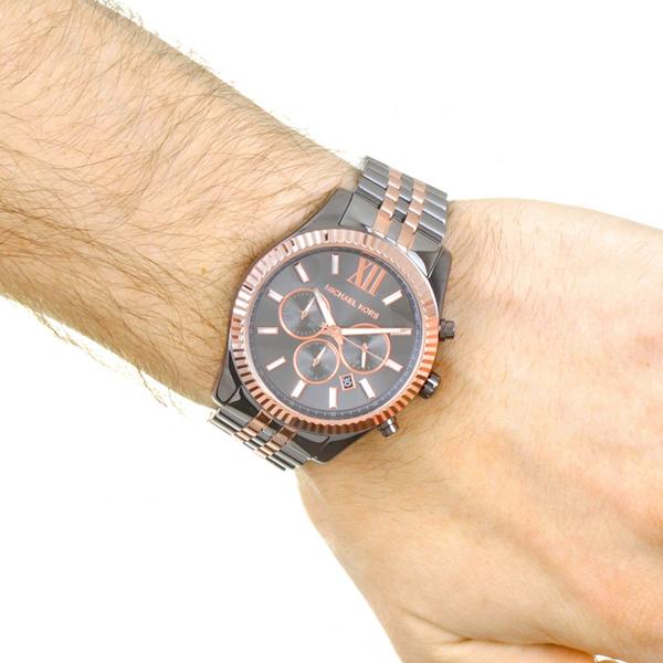 Wrist shot of Michael Kors Lexington chronograph with rose gold bezel and steel bracelet