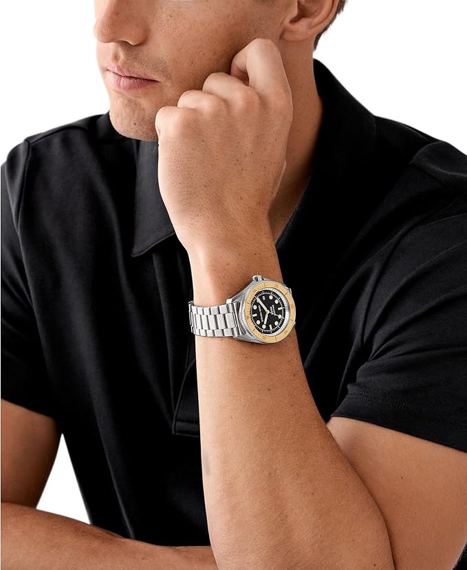 Michael Kors Maritime watch worn on wrist with silver bracelet and black dial