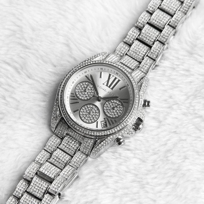 Michael Kors Mini Bradshaw silver watch worn on wrist with crystal-embellished band