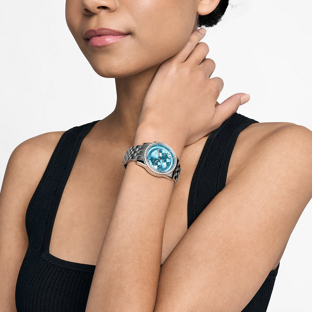 Michael Kors Mini Bryant MK7539 silver-tone watch worn on wrist with blue dial visible