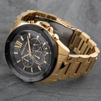 Michael Kors MK8848 Brecken gold chronograph watch at angle on textured background