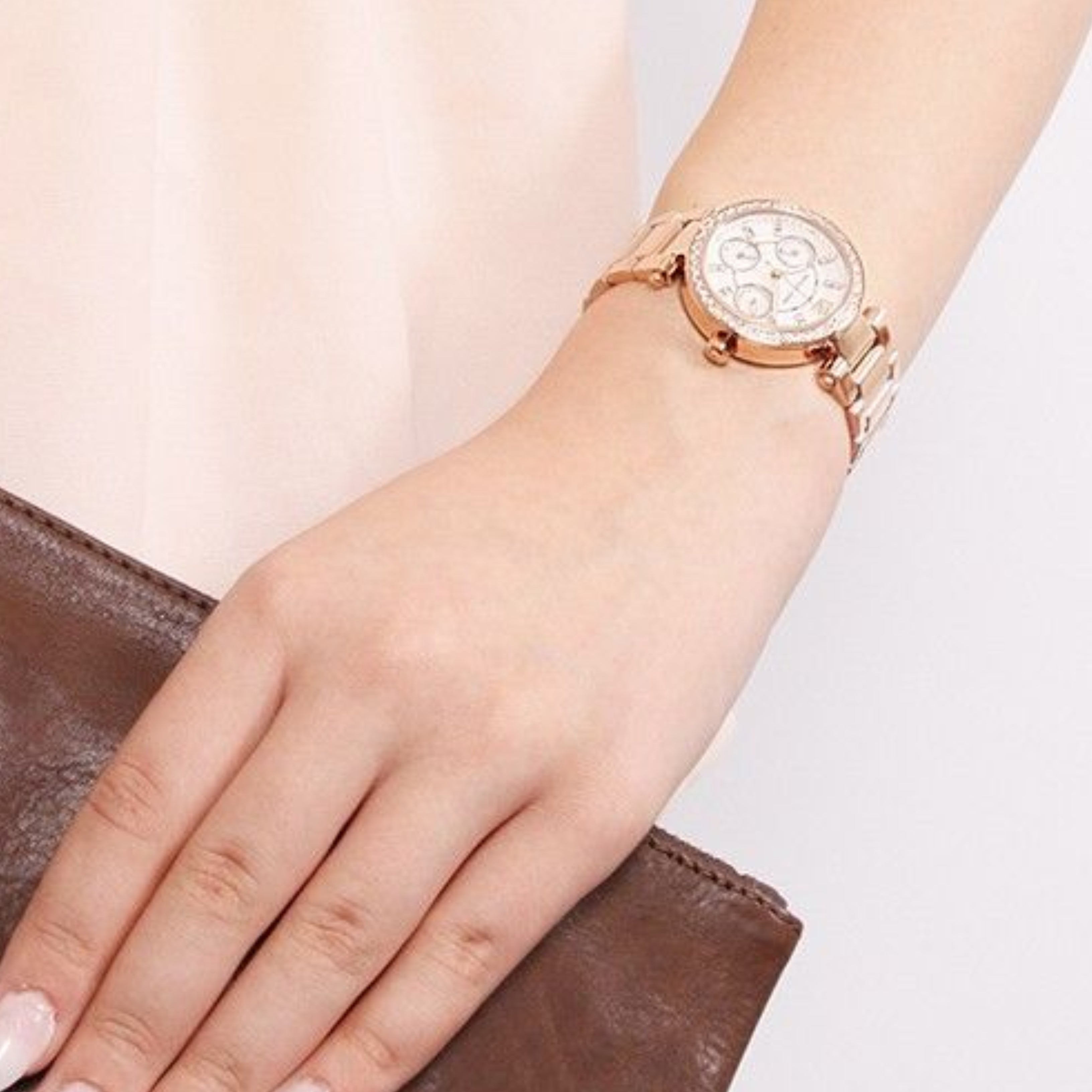 Michael Kors Parker rose gold chronograph watch on wrist with white dial