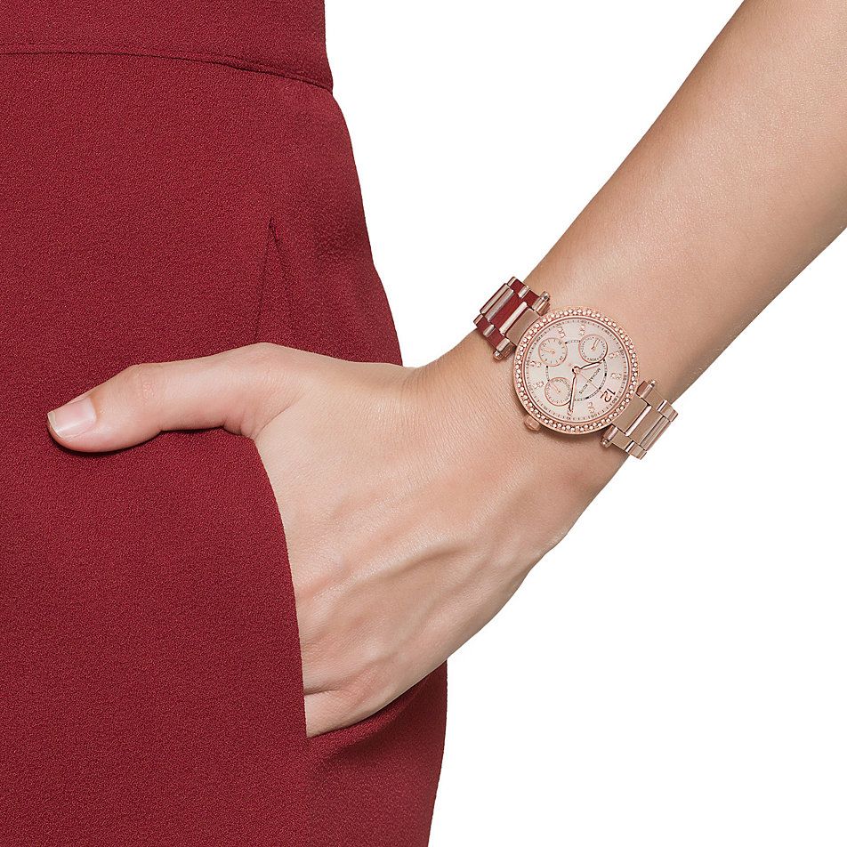 Michael Kors Parker rose gold watch worn on wrist with burgundy sleeve