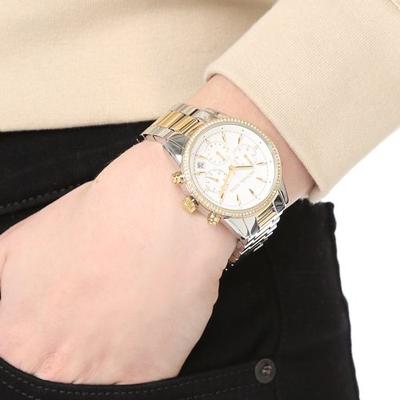 Michael Kors Ritz chronograph watch worn on wrist with white dial and mixed metal bracelet