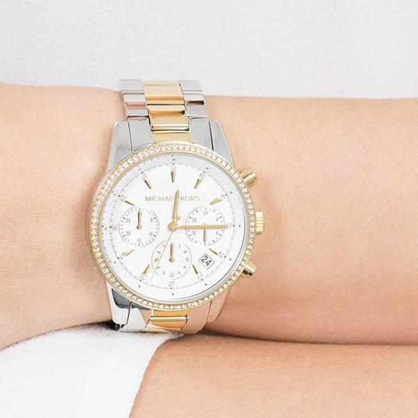 Michael Kors Ritz chronograph watch on wrist featuring crystal white dial and diamond bezel