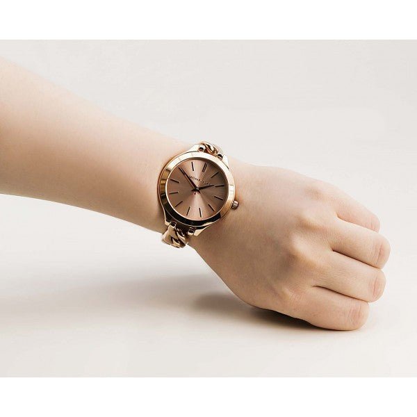 Michael Kors Slim Runway Twist watch worn on wrist showing rose dial and chain bracelet