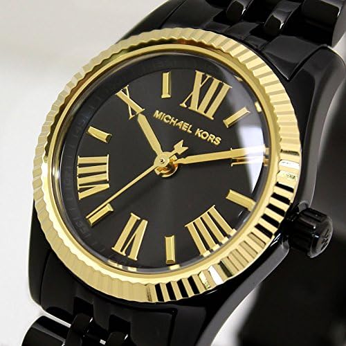 Close-up detail of Michael Kors Lexington dial with black background and gold-tone Roman numeral markers