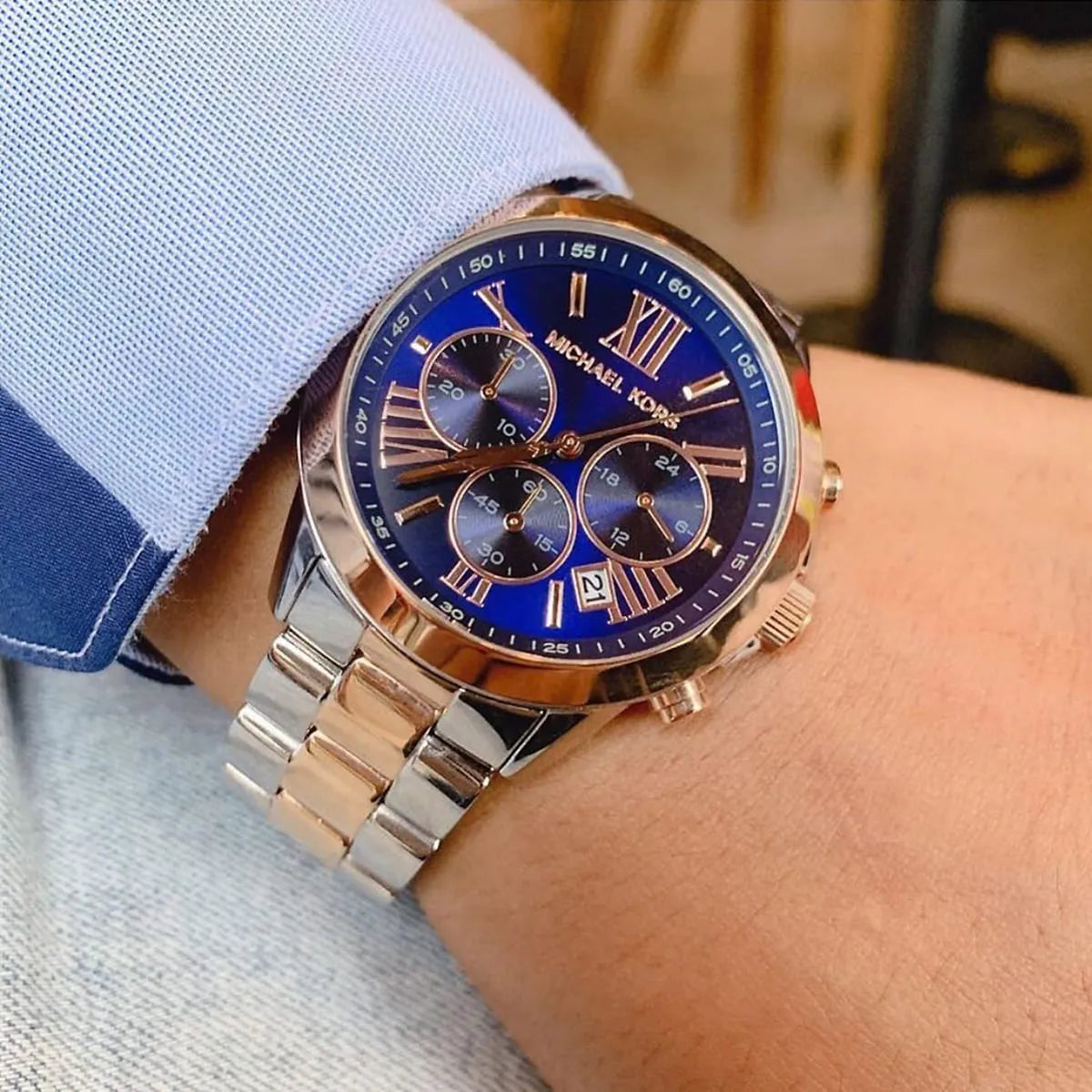 Michael Kors Bradshaw women's chronograph on wrist displaying blue face and metal strap