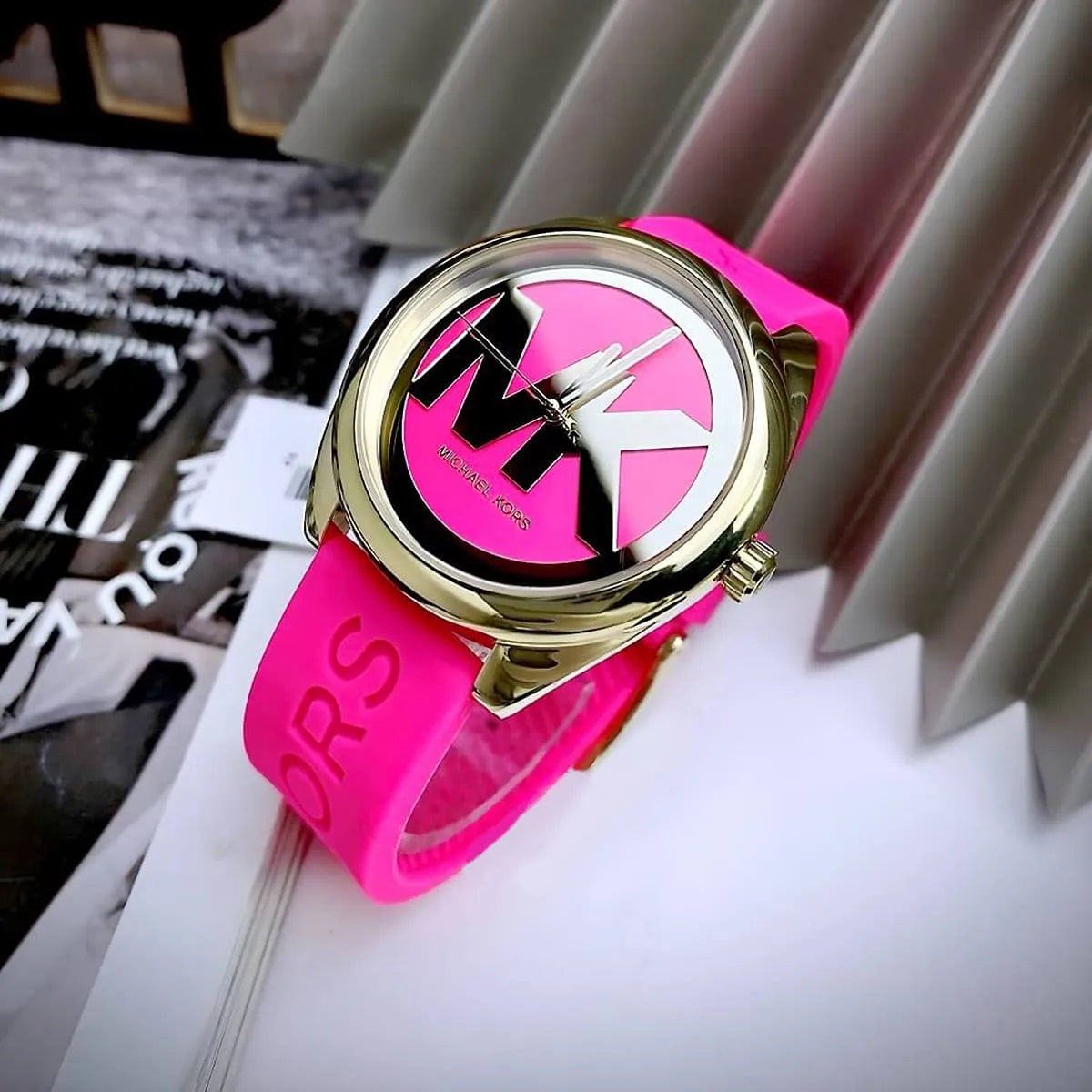 Michael Kors Janelle women's watch on-wrist flat lay displaying dial and pink rubber band