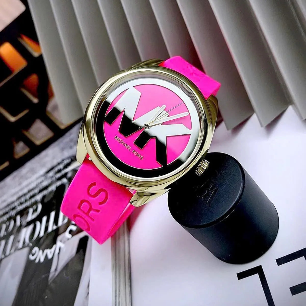 Michael Kors Janelle watch on-wrist showing bold MK logo and pink dial detail