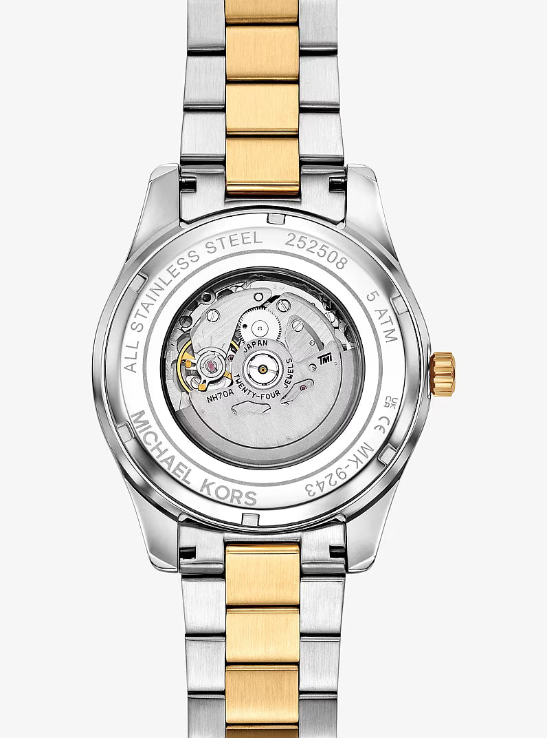 Michael Kors Lexington caseback showing automatic movement and two-tone bracelet detail