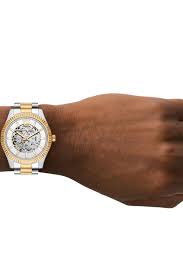 Michael Kors Lexington 45mm automatic watch worn on wrist showing two-tone design