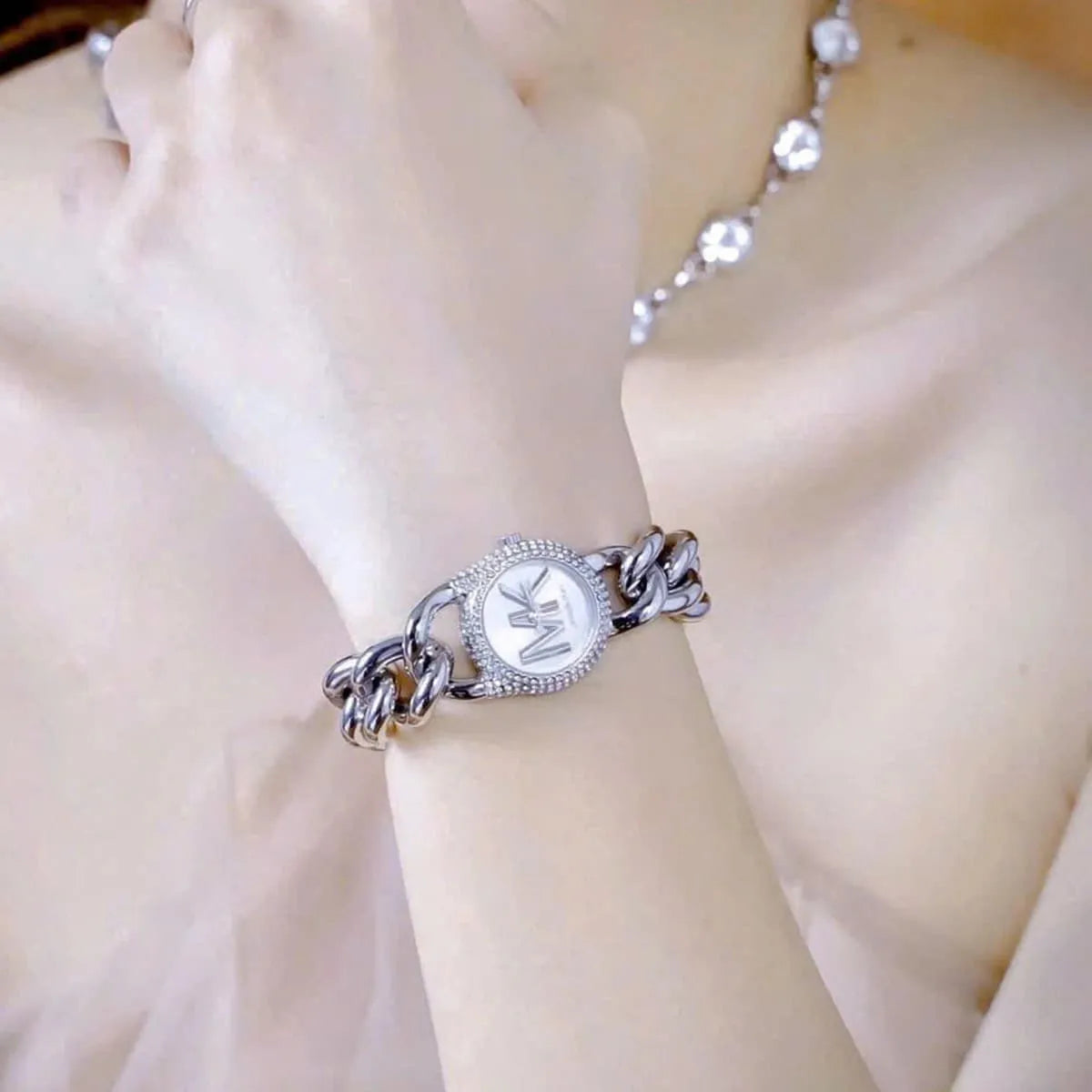 Michael Kors Liliane silver watch worn on wrist with crystal strap details