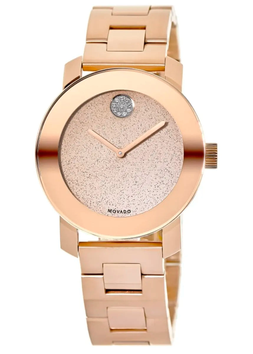 Close-up of Movado Bold bronze textured dial with blue crystal dot and white hands