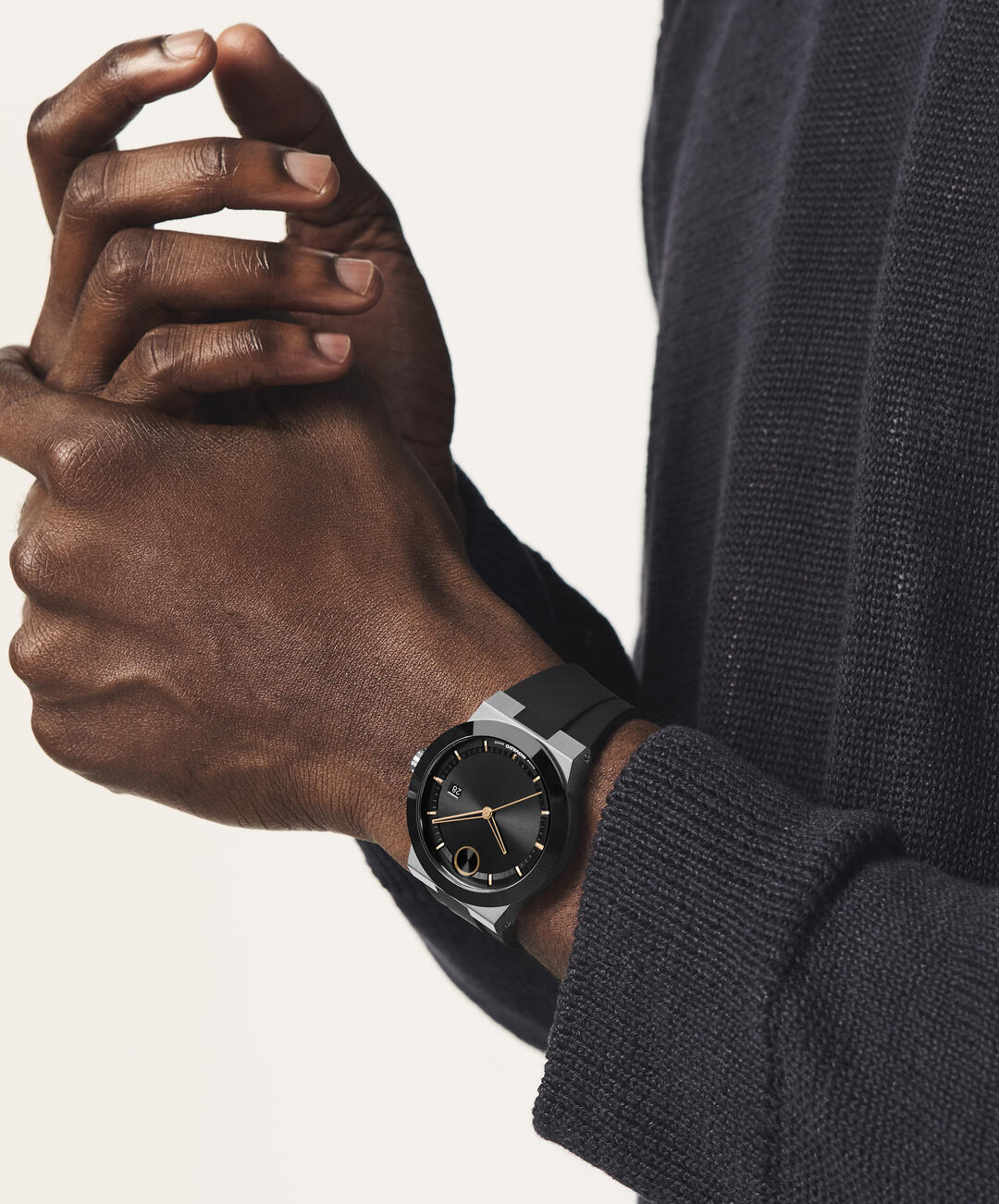Movado Bold watch worn on wrist showing cherry dial and rose gold case