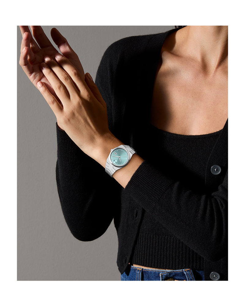 Movado Bold Quest watch on wrist showing blue seafoam dial and stainless steel case