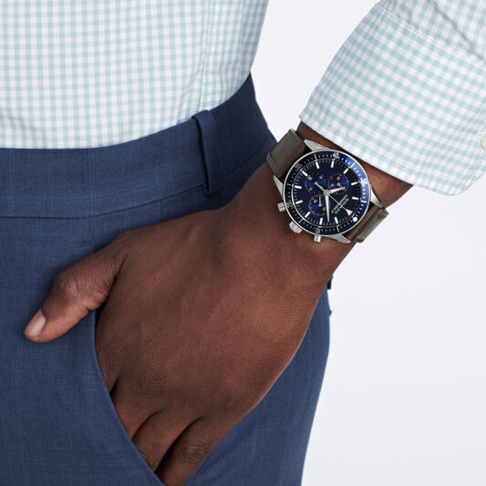 Movado Heritage chronograph worn on wrist with navy dial and brown strap
