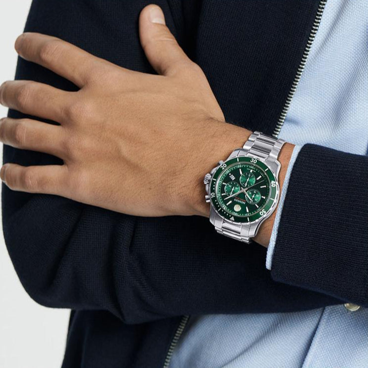 Movado Series 800 chronograph green dial watch worn on wrist with stainless steel band