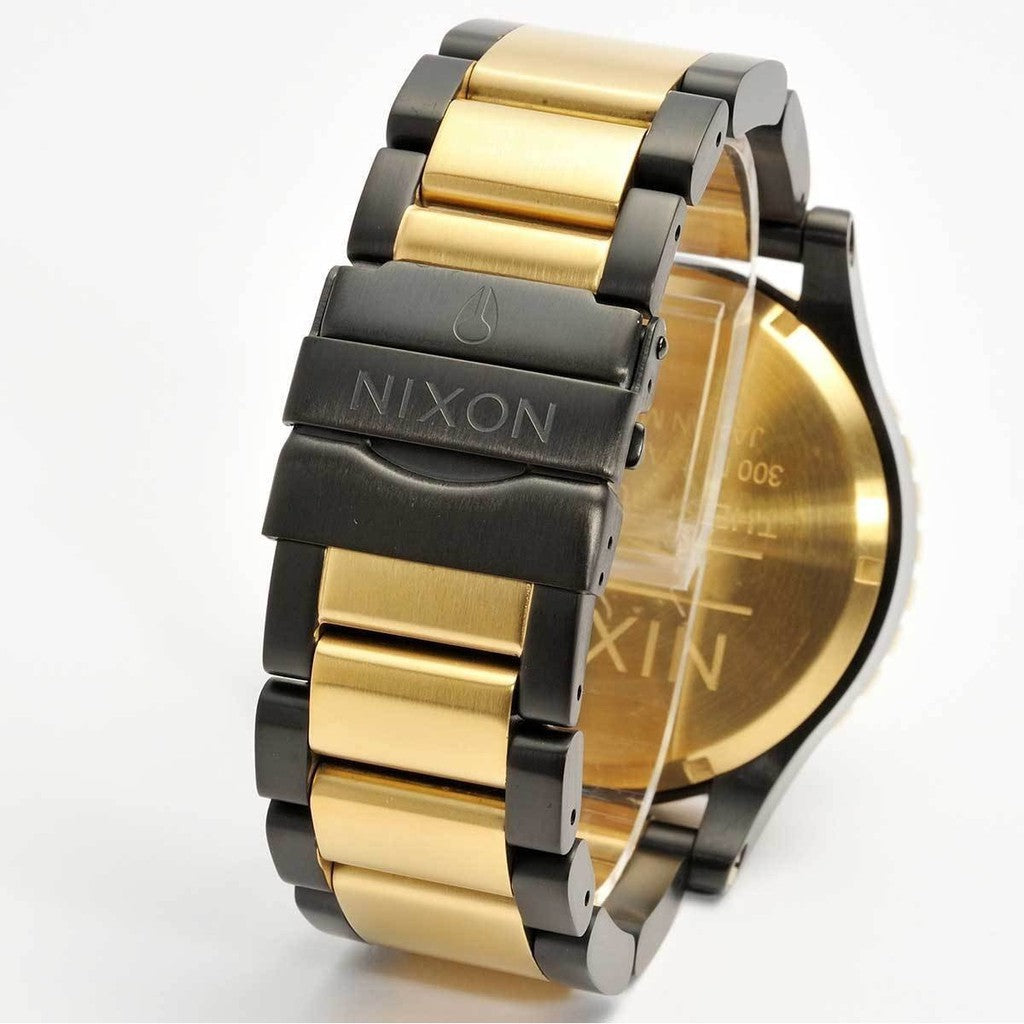Two-tone gold and black stainless steel bracelet of Nixon 51-30 watch with engraved case back