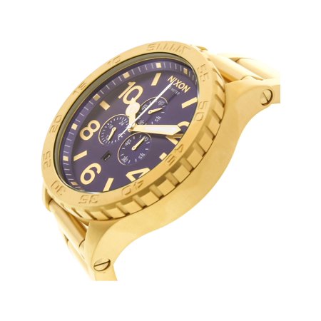 Side angle view of Nixon 51-30 Chrono showing gold-tone stainless steel case profile and blue dial