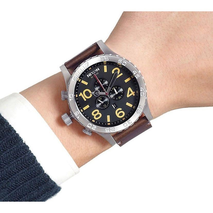 Nixon 51-30 Chrono watch worn on wrist showing black dial with yellow numerals and chronograph subdials