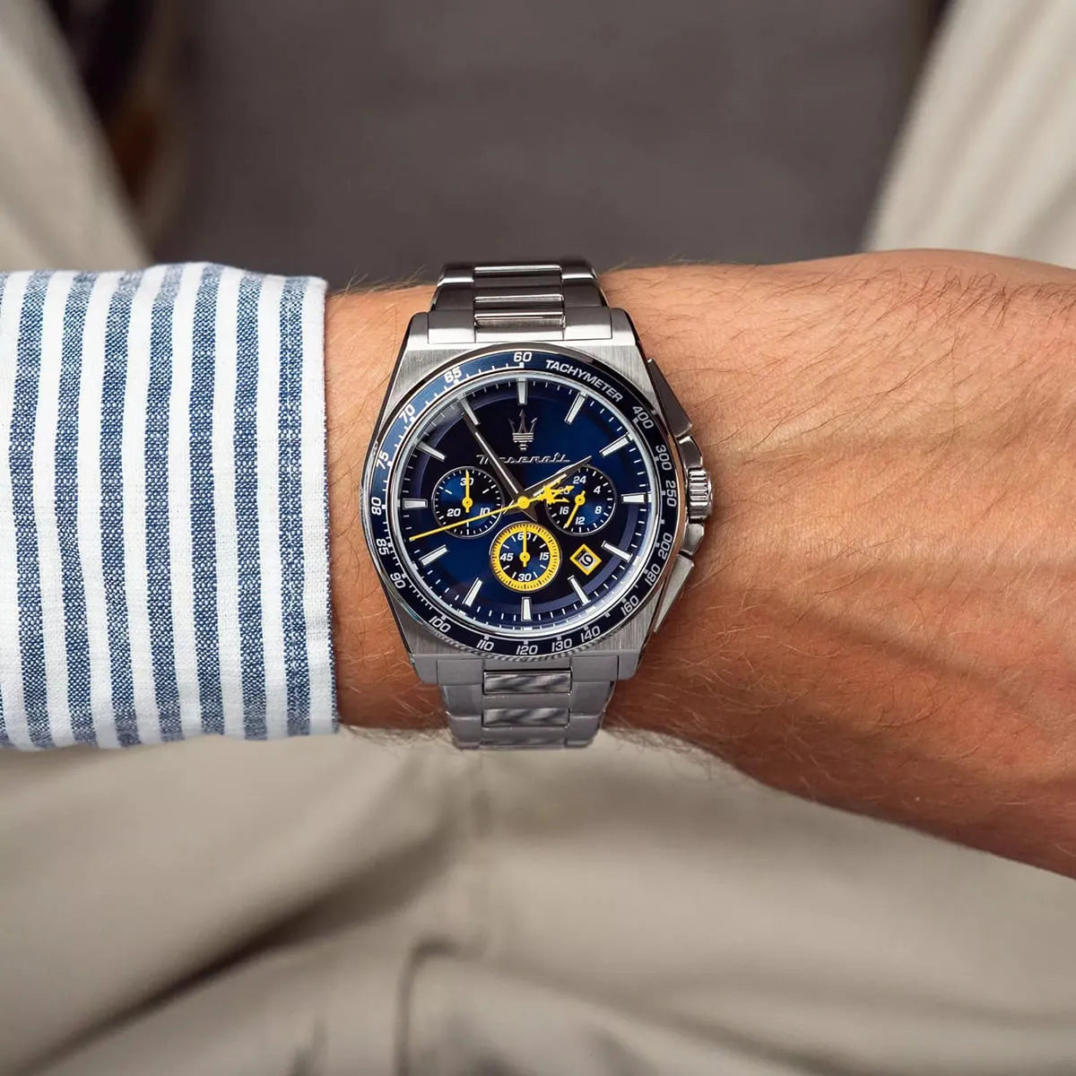 Maserati Velocitá 43mm chronograph watch worn on wrist with striped shirt sleeve