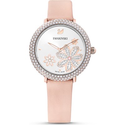 Swarovski women's watch with crystal case, white face with flower motif, and pink leather strap