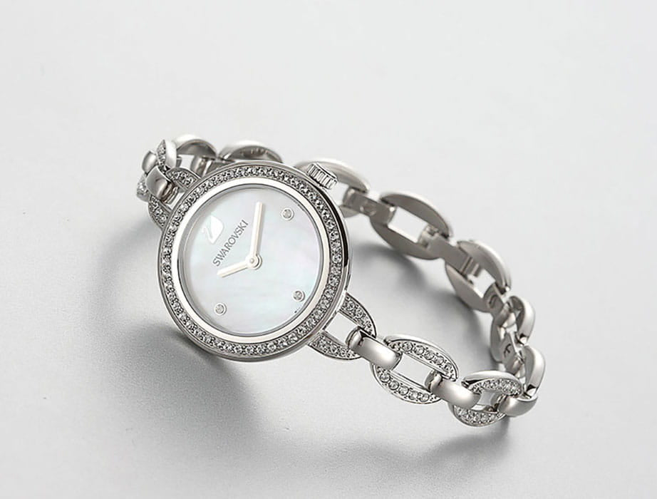 Swarovski Aila Mini watch on wrist, showing white dial and crystal-embellished bracelet