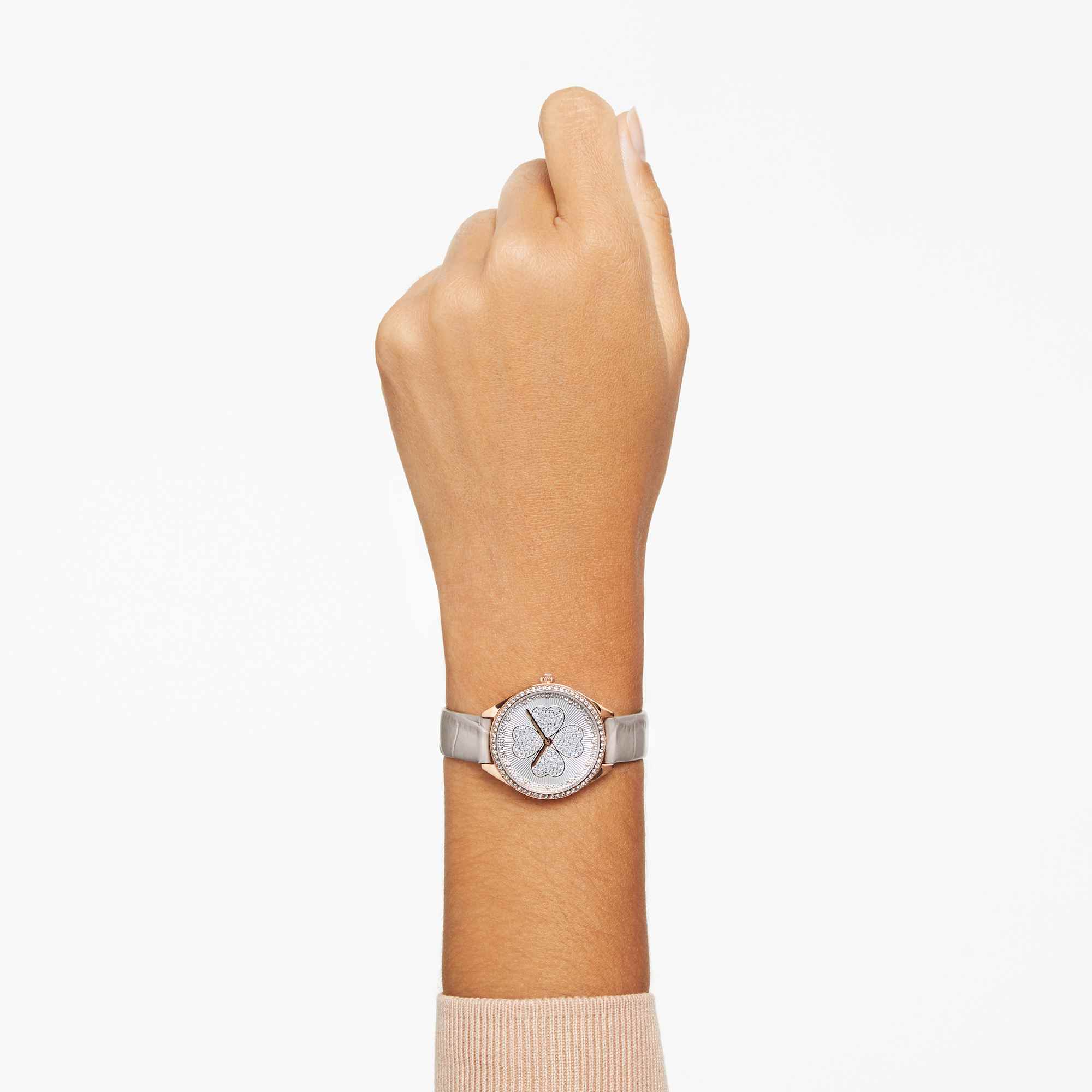 Swarovski Attract Clover watch worn on wrist with silver dial and grey leather strap