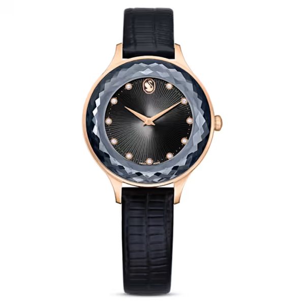 Swarovski Crystalline Aura women's watch with rose gold case, blue crystal bezel, black dial, and black leather strap
