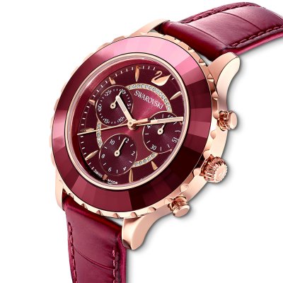 Three-quarter angle of Swarovski gold watch with burgundy chronograph dial and leather strap