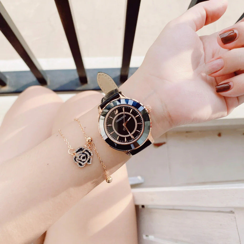 Swarovski Octea Lux watch worn on wrist showing black dial and rose-gold case