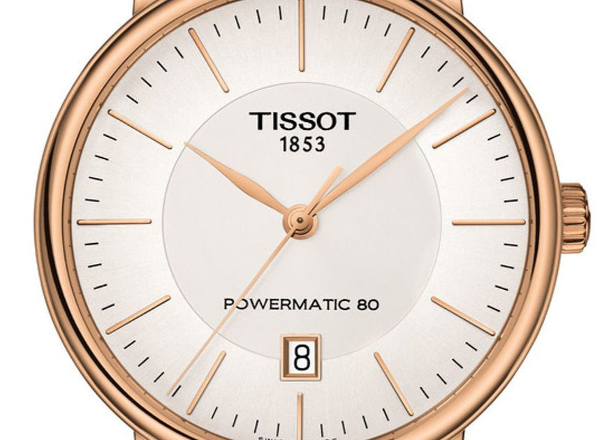 Close-up of Tissot Carson dial with white face, rose gold hands, and date window