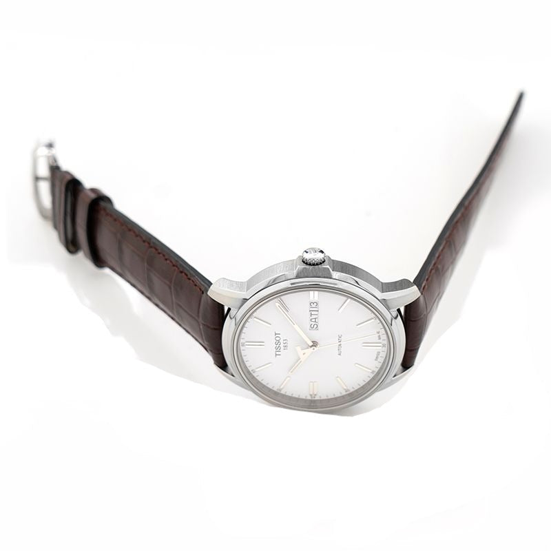 Tissot Automatics III automatic watch worn on wrist with brown leather strap