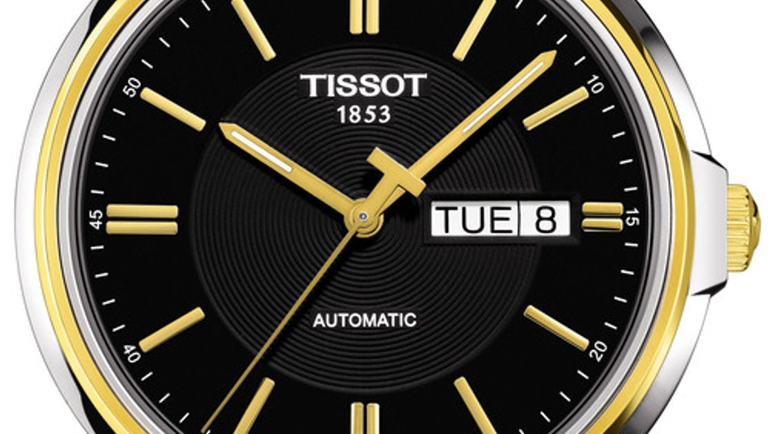 Tissot Automatics dial detail with black sunburst finish, gold-tone indices, day-date window