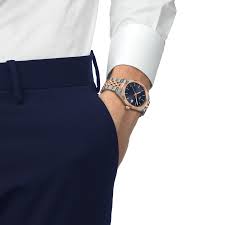Tissot Ballade watch on wrist with blue dial and two-tone bracelet