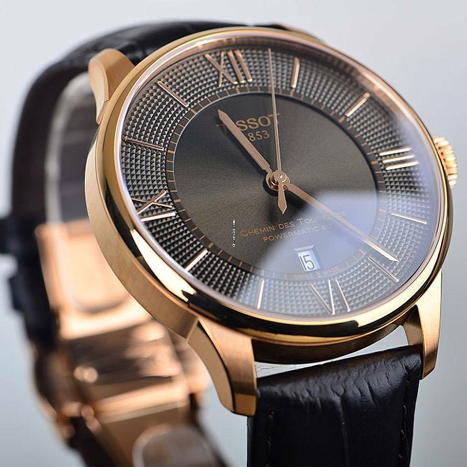 Close-up of Tissot Chemin Des Tourelles bronze dial with Roman numerals and rose gold hands