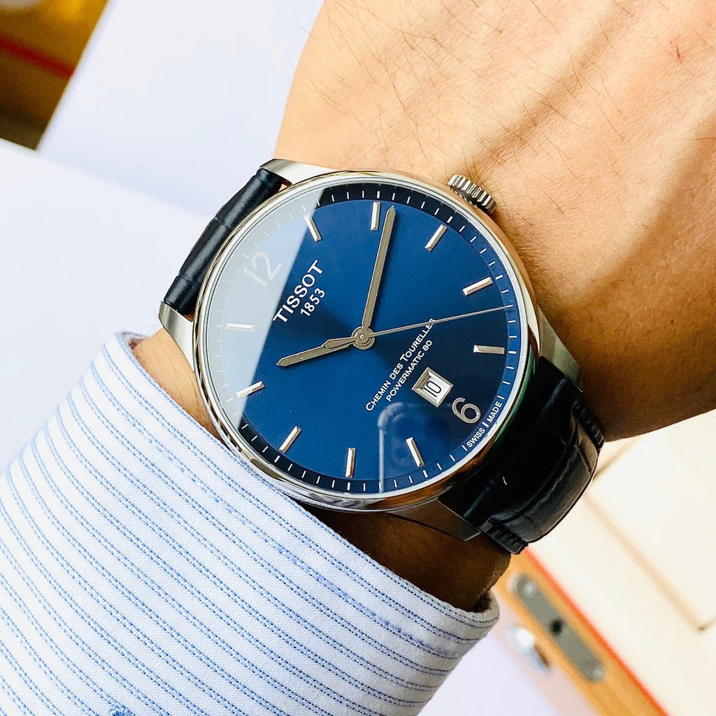 Tissot Chemin Des Tourelles Powermatic 80 blue watch on wrist with dark leather strap