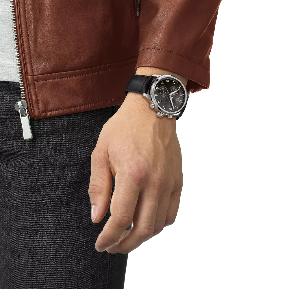 Tissot Chrono XL Classic black dial chronograph worn on wrist with leather jacket