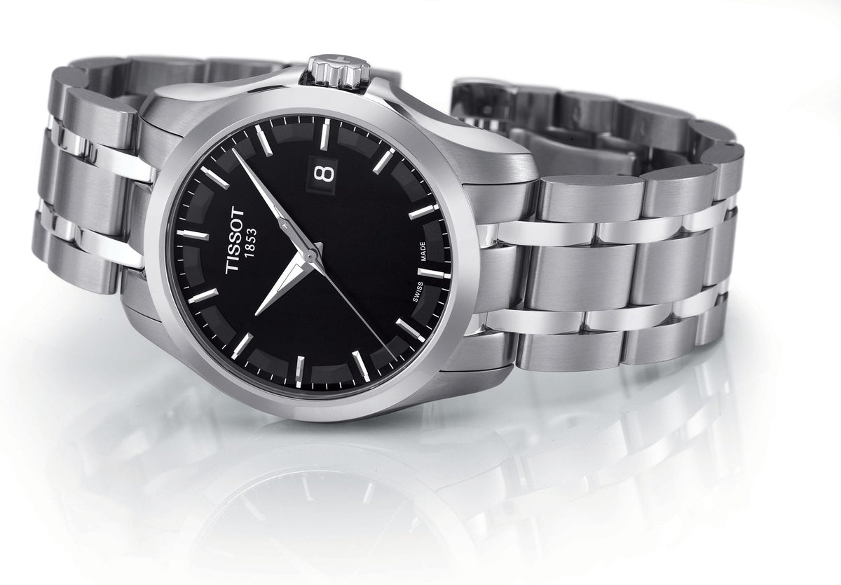 Tissot Couturier watch with stainless steel bracelet and black dial on white background