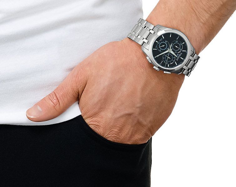 Tissot Couturier chronograph watch worn on wrist, displaying black dial and steel bracelet