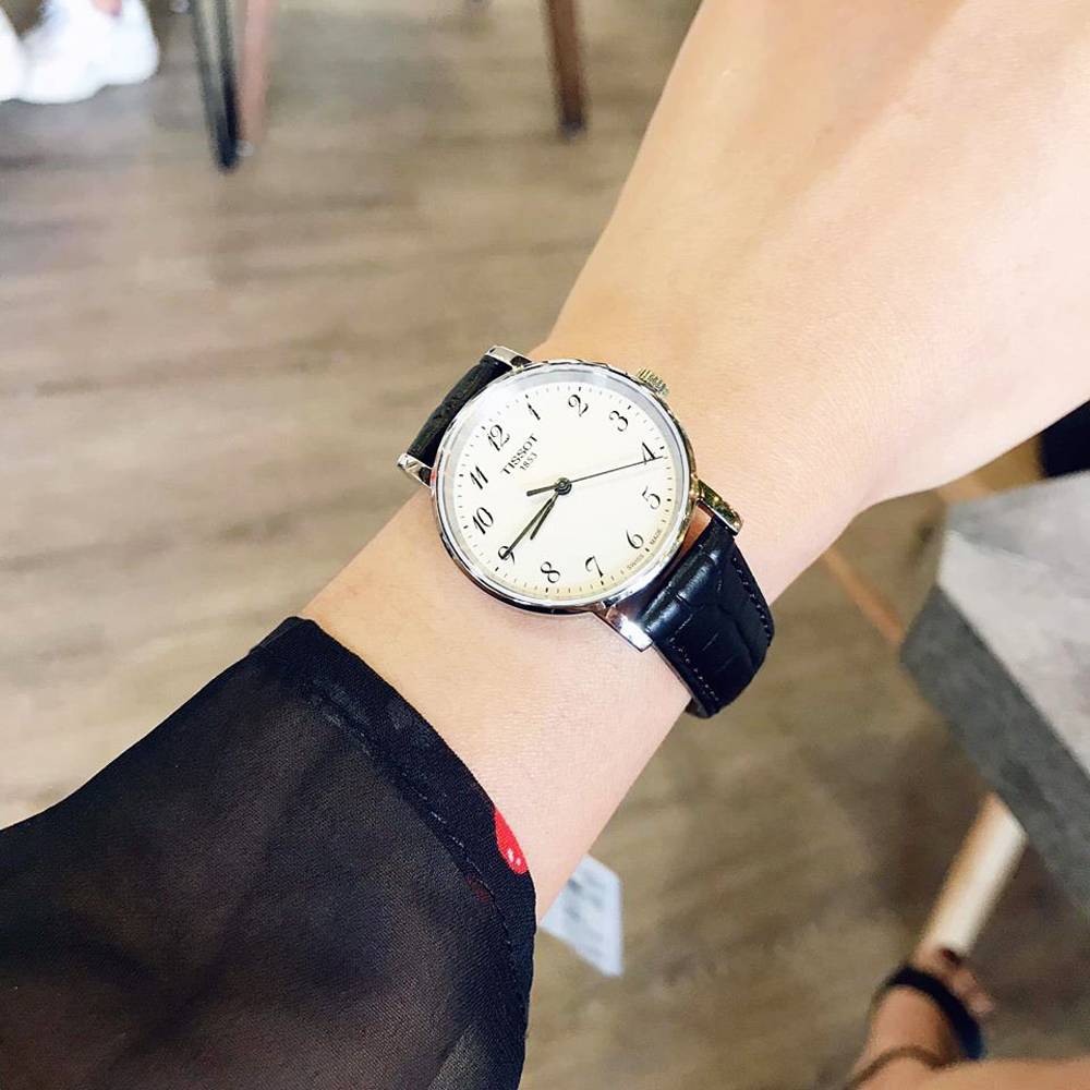 Tissot Everytime Small women's watch worn on wrist with black leather strap