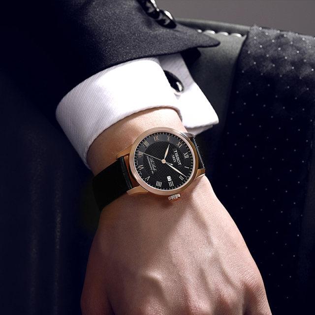 Tissot Le Locle Powermatic 80 worn on wrist showing black dial and rose gold case