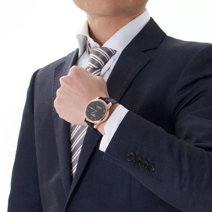 Tissot Le Locle Powermatic 80 on wrist with dark suit and white shirt cuff