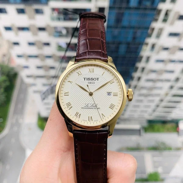 Tissot Le Locle Powermatic 80 watch worn on wrist with brown leather strap