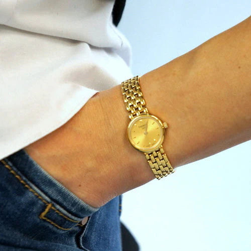 Tissot Lovely women's watch worn on wrist with yellow gold PVD steel bracelet