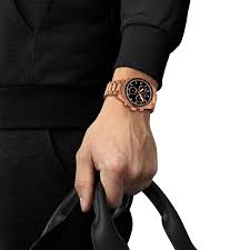 Tissot PR516 chronograph worn on wrist with black dial and rose gold case